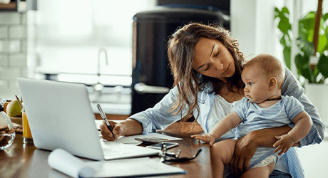 woman holding a baby while working