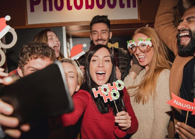 People celebrating holiday party with selfie