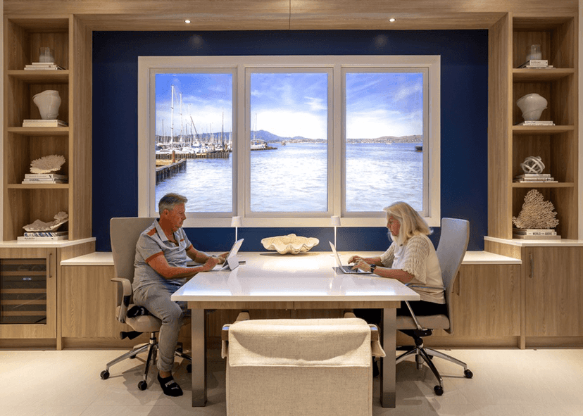 Man and woman working in front of LiquidView digital windows